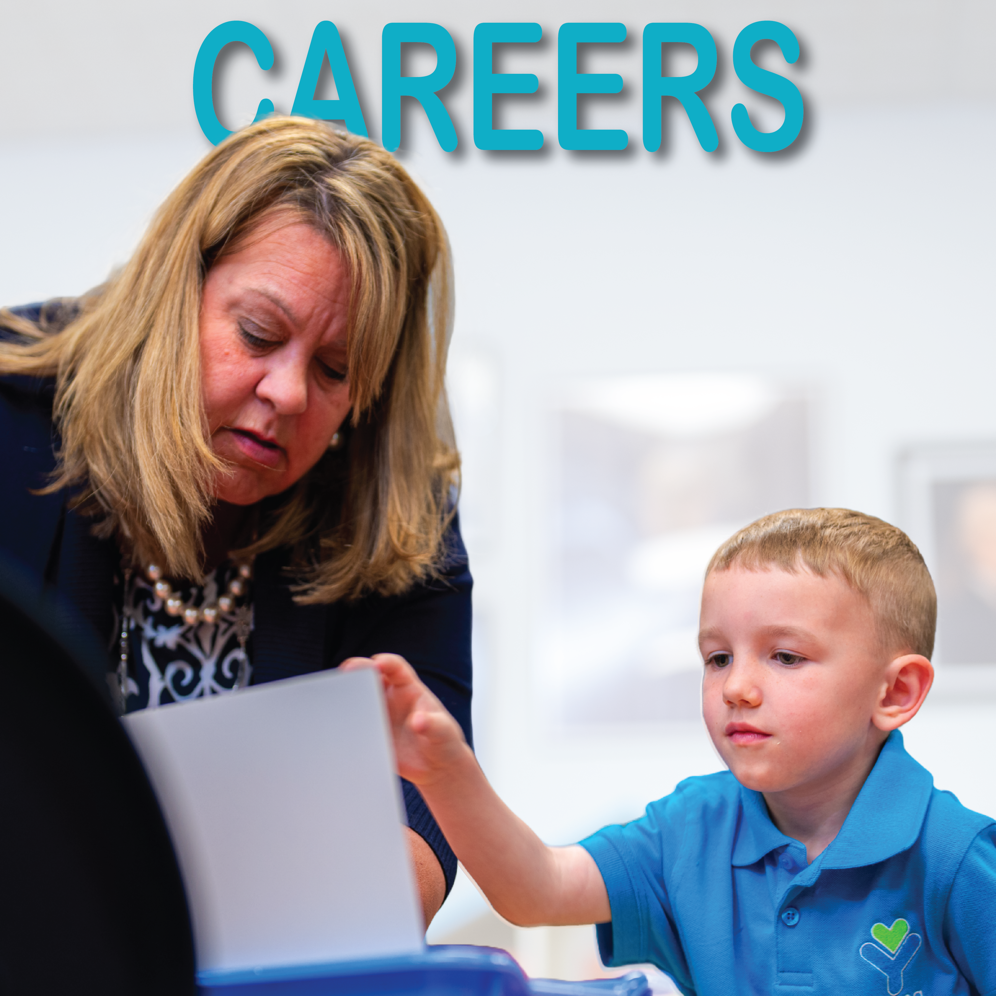 teacher with a student now hiring at young hearts preschool